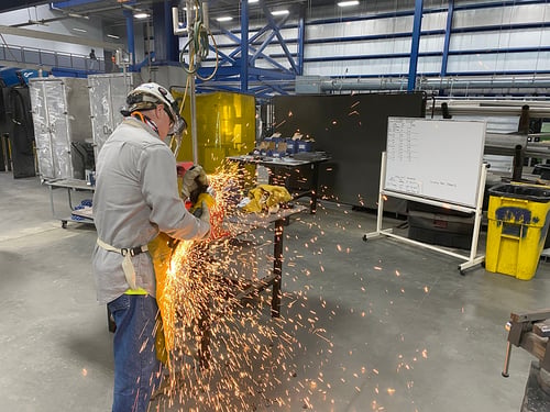 Weiler Abrasives expert conducting product testing at a shipbuilding facility
