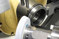 Grinding bearing parts