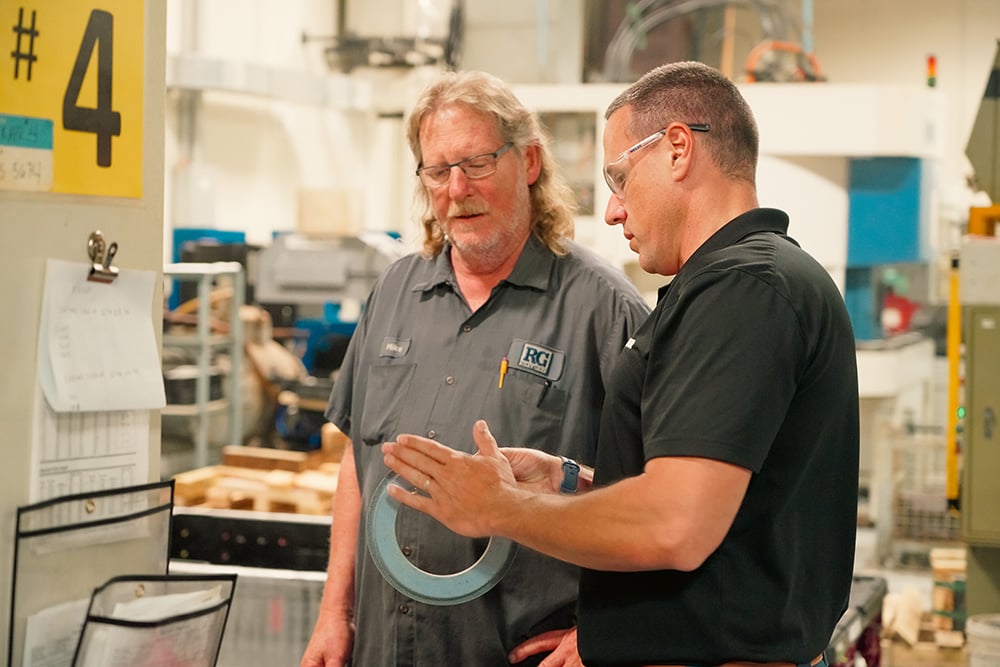 Weiler application specialist discussing a grinding application with an operator.