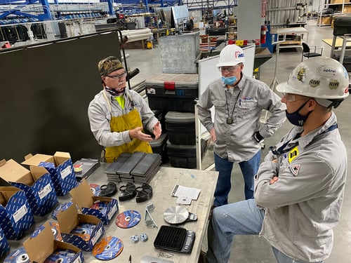 David Jescovitch of Weiler Abrasives visits workers in a shipbuilding facility during abrasive product testing.