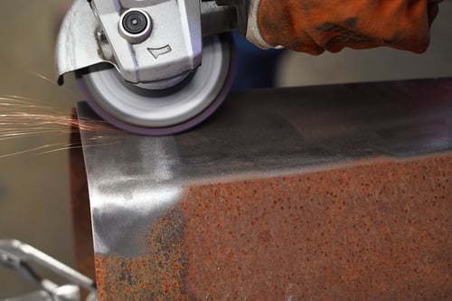 Surface conditioning strip disc removing rust from a metal part