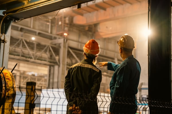 This is an image of an abrasive expert consulting with a metalworking professional.