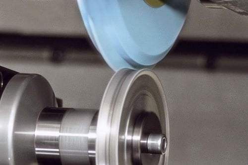 Action of a profile grinding wheel being dressed to demonstrate the method used.