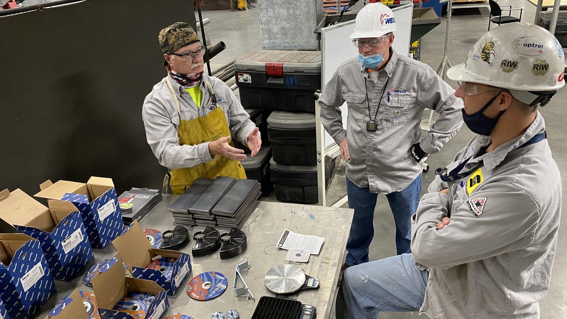 Weiler team and the welding engineer discussing the testing process.
