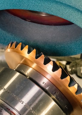 Bevel wheel grinding a gear.